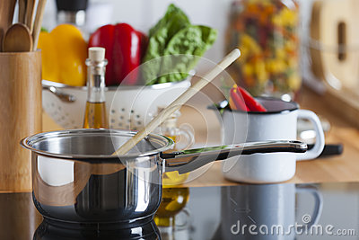 cooking-pot-wooden-spoon-ceramic-hob-38150408.jpg